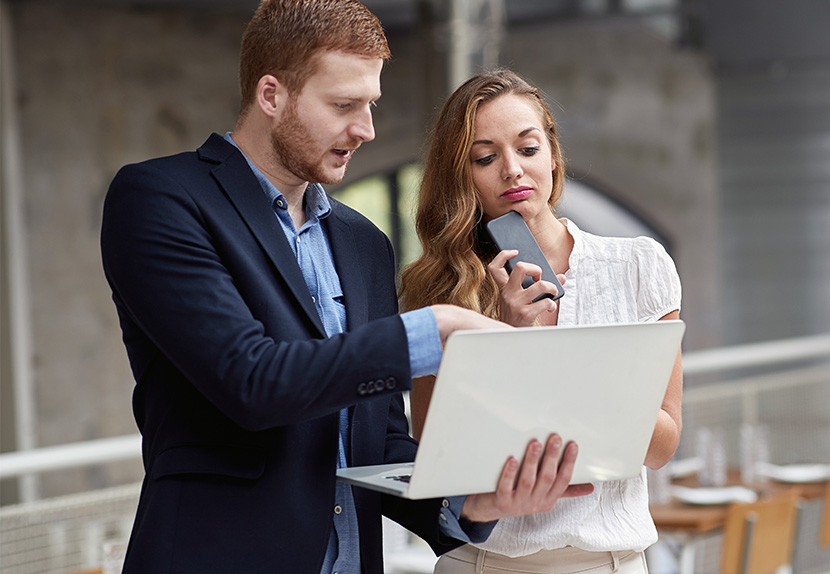 A man and a woman working on a lpatop