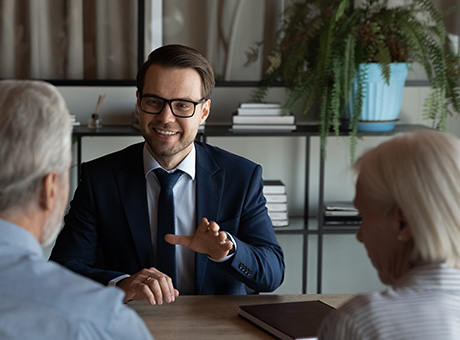 An Investment Advisor engages in a discussion with an elderly couple about available investment options.
