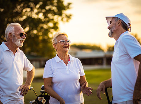 A gathering of retired individuals is relishing a day outdoors on the golf range.