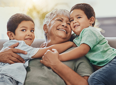 Basking outdoors, a Landmark member, holding a Certificate account, relishes relaxation with her two cherished grandchildren by her side.