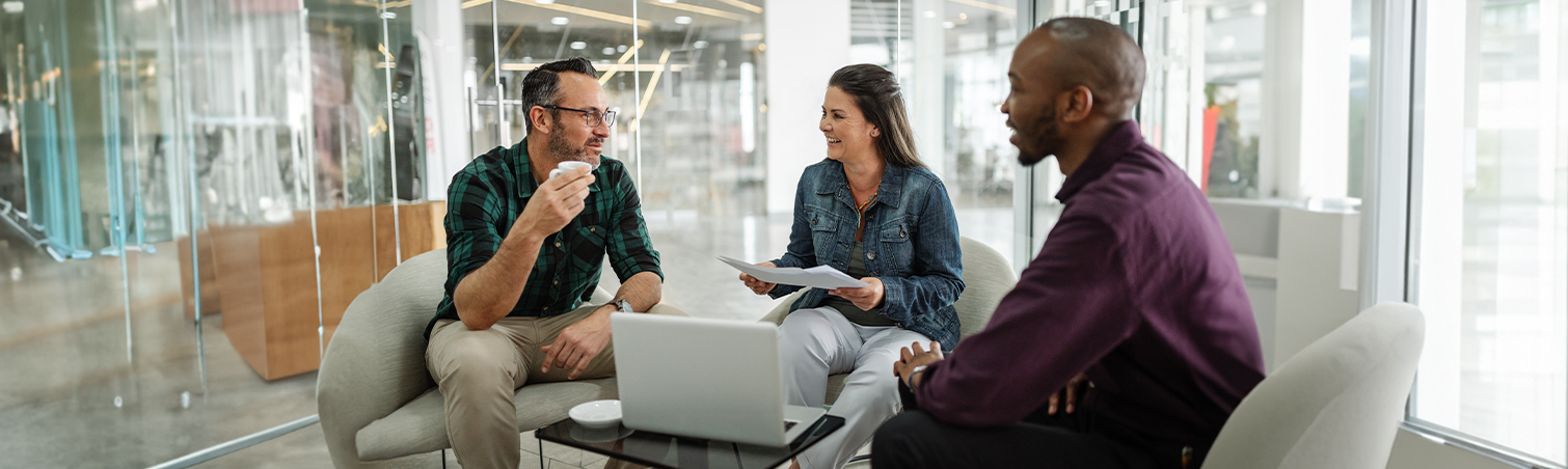 Couple sitting in an office with financial consultant looking at documents