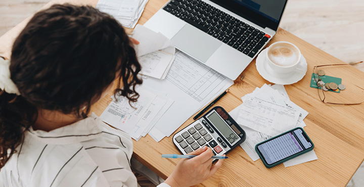 A member sits at a table as they look at the funds that they are building for a rainy day.