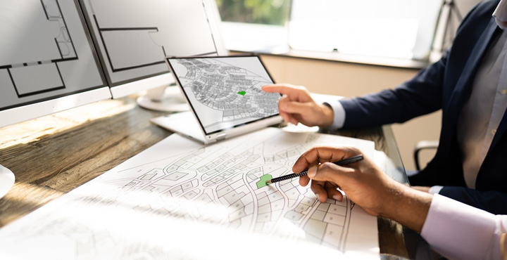 two individuals are looking at remodeling plannings. 