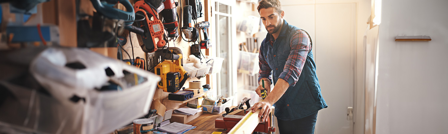 A member is in their workshop at home getting ready trim a piece of wood.