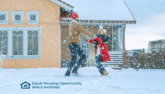 Couple in front of house in winter