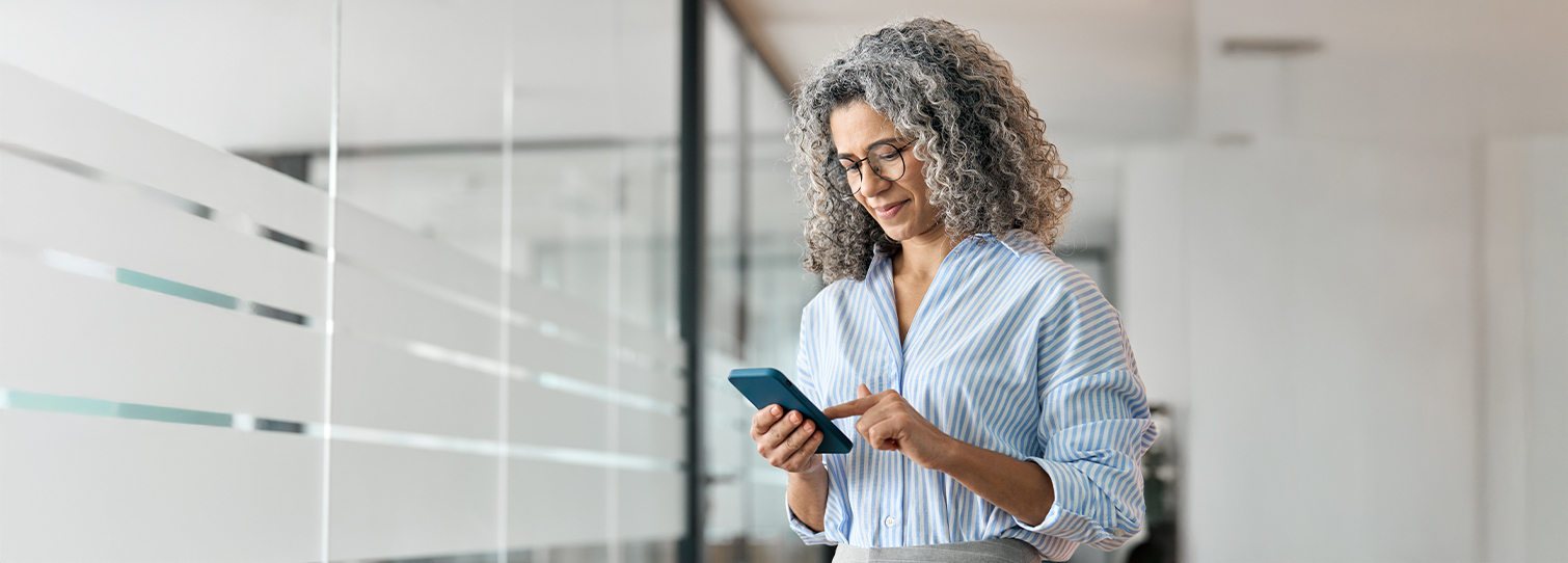 Woman looking at retirement rollover options on her mobile device