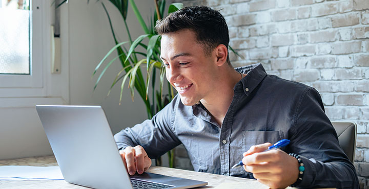 man looking at his laptop