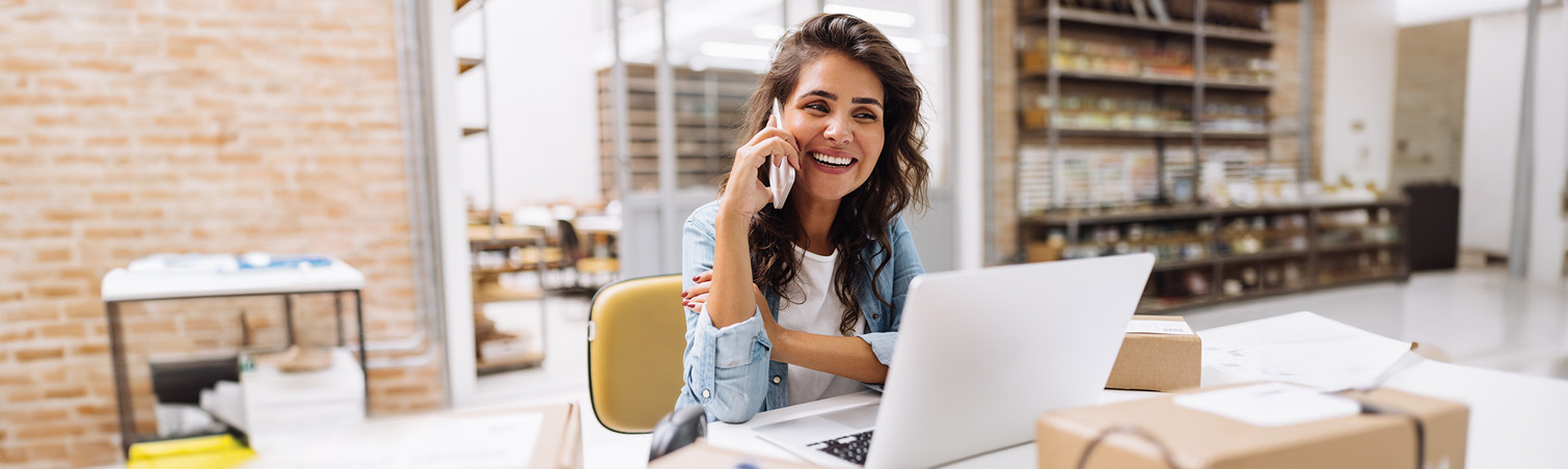 " A member with a smile on their face is on their phone, intrigued by the various ways they can engage in banking."