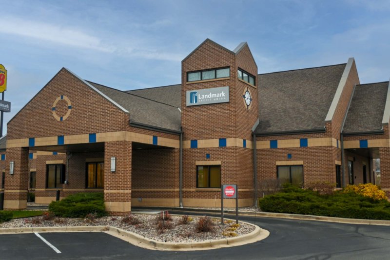 Exterior view of Germantown branch - large brown brick building with car turnaround in foreground.