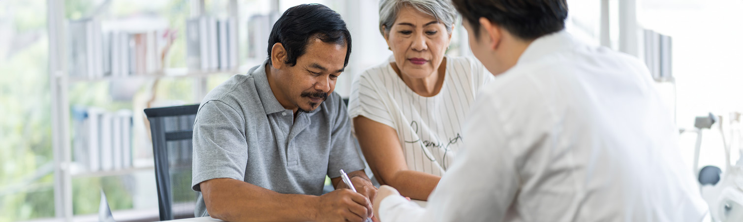 An older couple ismeeting with a financial advisor to speak regarding repairing their credit.
